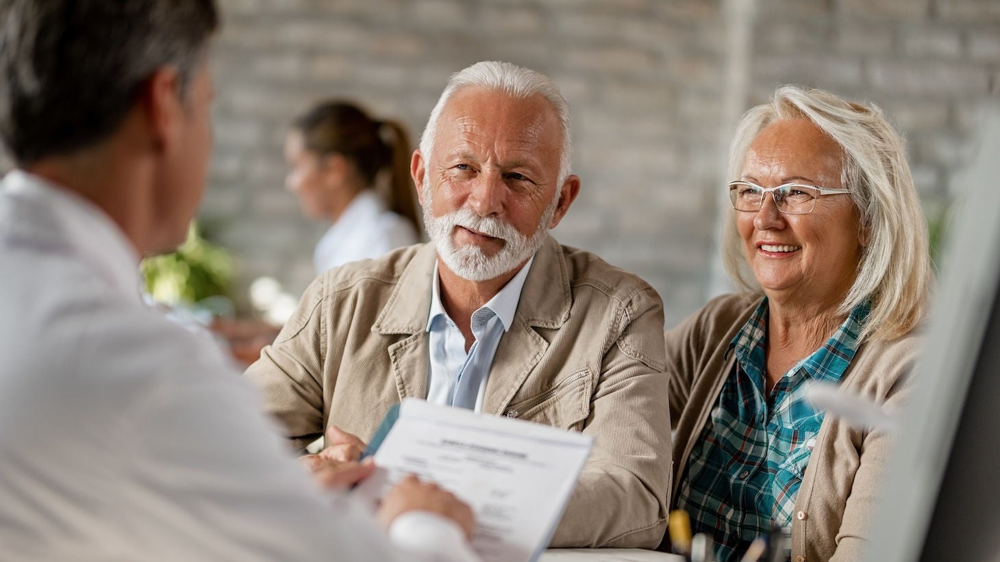 man and woman reviewing documents with an agent