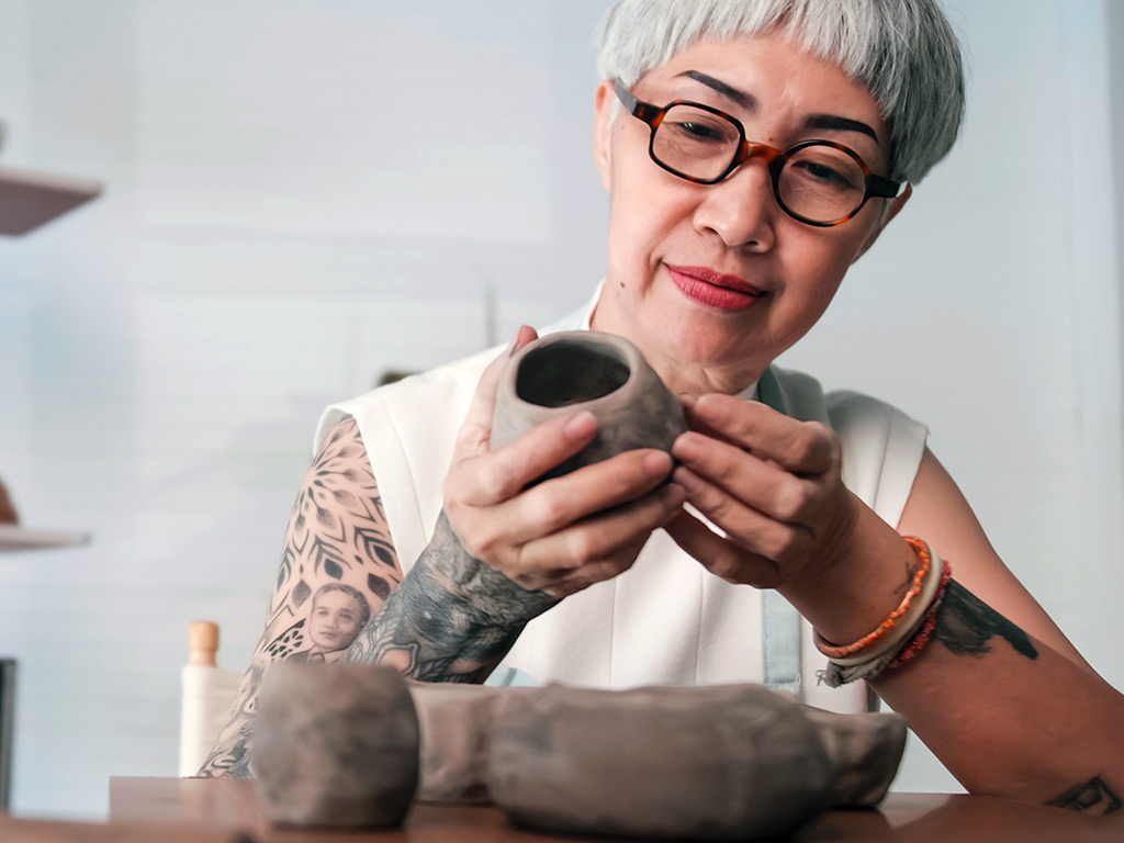 A woman painting pottery