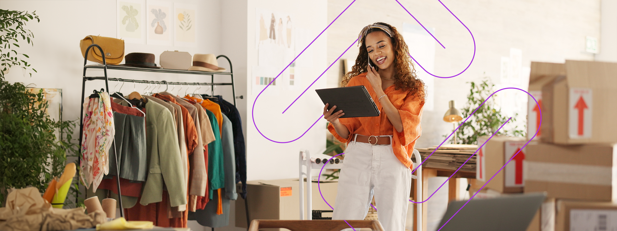 Woman on the phone reviewing a tablet device in her small shop.