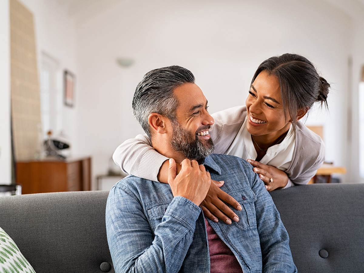 Couple on the couch together smiling